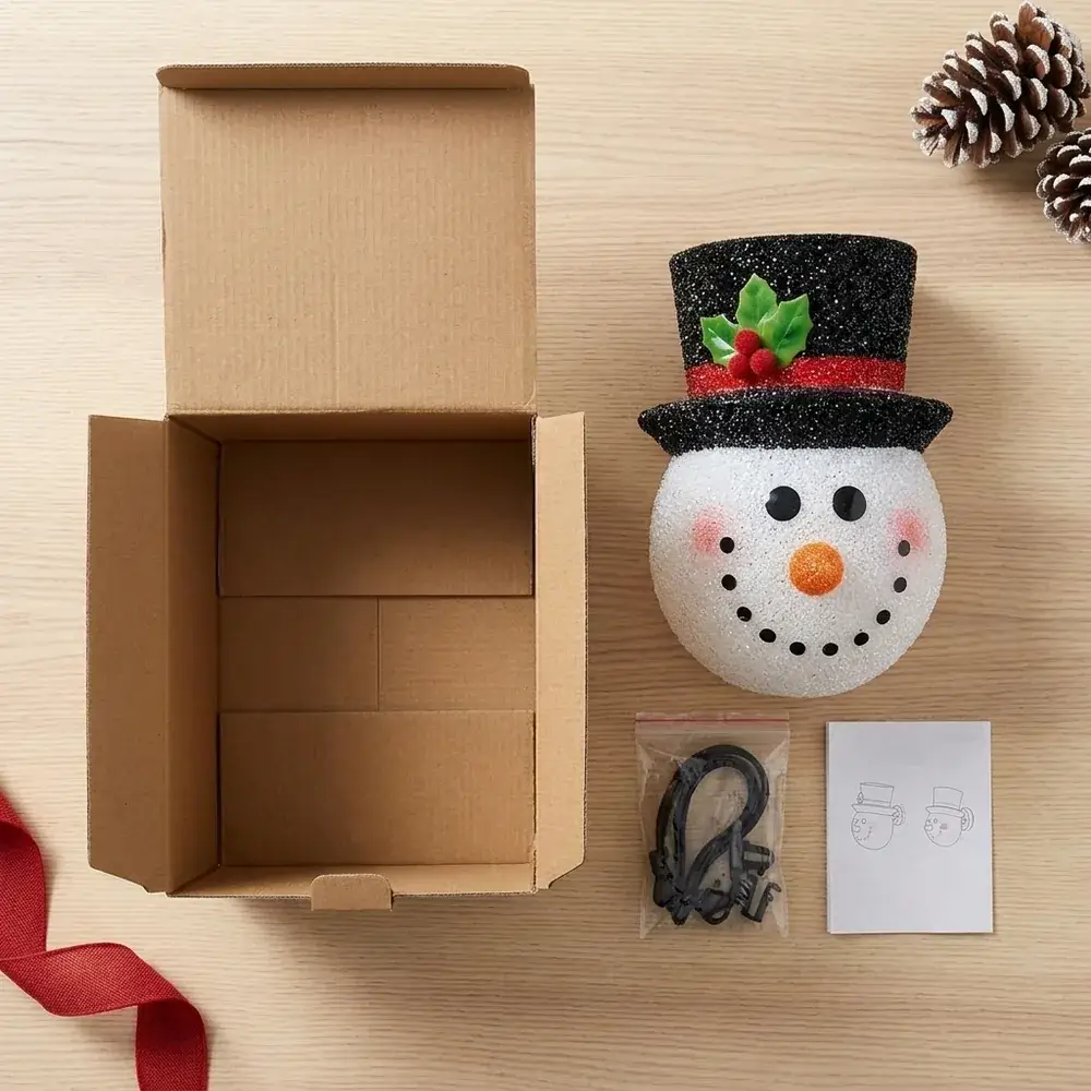 Conteúdo da caixa: boneco de neve com cartola, azevinho e fita vermelha, fixações e instruções